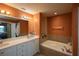 Bathroom boasting a double sink, quartz countertops and a soaking tub at 424 Luna Bella Ln # 316, New Smyrna Beach, FL 32168