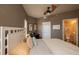 Comfortable bedroom featuring a ceiling fan, plush bedding, and an ensuite bathroom at 424 Luna Bella Ln # 316, New Smyrna Beach, FL 32168