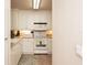 Well-maintained kitchen with white cabinets, modern appliances, and tile flooring at 424 Luna Bella Ln # 316, New Smyrna Beach, FL 32168