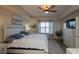 Spacious main bedroom featuring a ceiling fan, large window and neutral decor at 424 Luna Bella Ln # 316, New Smyrna Beach, FL 32168