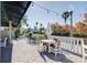Charming outdoor patio area surrounded by palm trees and lush landscaping at 424 Luna Bella Ln # 316, New Smyrna Beach, FL 32168