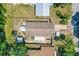 Overhead view revealing the home's layout, including the back patio and storage sheds in the fenced yard at 428 Perdita Ave, Edgewater, FL 32132