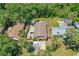 Aerial view showing a home with a fenced backyard, sheds, and proximity to lush greenery at 428 Perdita Ave, Edgewater, FL 32132