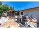 Relaxing backyard patio with a screened-in porch and an outdoor grill, ideal for entertaining at 428 Perdita Ave, Edgewater, FL 32132