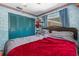 Bedroom with a large bed, blue bi-fold closet doors, and themed wallpaper trim at 428 Perdita Ave, Edgewater, FL 32132