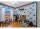 Bedroom with blue patterned wallpaper, built-in shelves, and window at 428 Perdita Ave, Edgewater, FL 32132