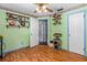 Light green bedroom with open doorway, shelves, and a cat tree at 428 Perdita Ave, Edgewater, FL 32132