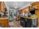 Kitchen with wooden cabinetry, wood-look flooring, and stainless-steel appliances at 428 Perdita Ave, Edgewater, FL 32132