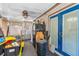 Enclosed sunroom with a refrigerator, blue double doors and black trash can at 428 Perdita Ave, Edgewater, FL 32132