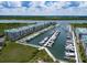 Aerial view of a marina with boat docks and waterfront condo buildings at 4620 Riverwalk Village Ct # 7306, Ponce Inlet, FL 32127