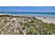 Beach access with wooden stairs leading down to the sand and surf at 4620 Riverwalk Village Ct # 7306, Ponce Inlet, FL 32127