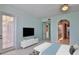 Bedroom with staged furniture and doors to the outside and bathroom at 4620 Riverwalk Village Ct # 7306, Ponce Inlet, FL 32127