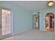 Bright bedroom featuring access to a private balcony and walk-in closet at 4620 Riverwalk Village Ct # 7306, Ponce Inlet, FL 32127