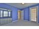 Bedroom featuring a mirrored closet, private exterior door, and bay window at 4620 Riverwalk Village Ct # 7306, Ponce Inlet, FL 32127