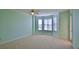 Bright bedroom with large windows and a ceiling fan at 4620 Riverwalk Village Ct # 7306, Ponce Inlet, FL 32127
