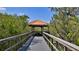 Picturesque walkway leading to a gazebo surrounded by verdant trees, offering a tranquil outdoor space at 4620 Riverwalk Village Ct # 7306, Ponce Inlet, FL 32127