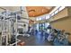 Well-equipped gym with modern exercise machines and natural light streaming through large windows at 4620 Riverwalk Village Ct # 7306, Ponce Inlet, FL 32127