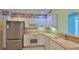 Bright kitchen features white cabinets, stainless steel refrigerator, and modern appliances at 4620 Riverwalk Village Ct # 7306, Ponce Inlet, FL 32127