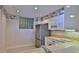 Compact kitchen with ample cabinets, stainless steel refrigerator, and neutral countertops at 4620 Riverwalk Village Ct # 7306, Ponce Inlet, FL 32127