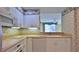 Modern kitchen with white cabinets, tile backsplash, and updated appliances at 4620 Riverwalk Village Ct # 7306, Ponce Inlet, FL 32127