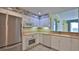 Well-maintained kitchen features white cabinetry, stainless steel refrigerator, and tile flooring at 4620 Riverwalk Village Ct # 7306, Ponce Inlet, FL 32127