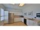 Clean kitchenette featuring stainless steel appliances, white cabinets, and tile flooring at 4620 Riverwalk Village Ct # 7306, Ponce Inlet, FL 32127