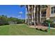 Well-maintained lawn with palm trees and bench seating, ideal for relaxing outdoors at 4620 Riverwalk Village Ct # 7306, Ponce Inlet, FL 32127