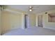 Living room with neutral carpet, ceiling fan, and multiple entryways at 4620 Riverwalk Village Ct # 7306, Ponce Inlet, FL 32127