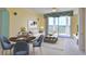 Nicely staged living room with dining area, stylish furniture, and a balcony view at 4620 Riverwalk Village Ct # 7306, Ponce Inlet, FL 32127