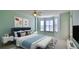 Serene bedroom featuring a large window, ceiling fan and comfortable bedding at 4620 Riverwalk Village Ct # 7306, Ponce Inlet, FL 32127