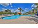 Community pool with palm trees, lounge chairs, and shade gazebos at 4620 Riverwalk Village Ct # 7306, Ponce Inlet, FL 32127