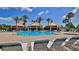 Community pool area with lounge chairs and palm trees at 4620 Riverwalk Village Ct # 7306, Ponce Inlet, FL 32127
