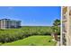 Scenic view from the condo's balcony of palm trees, lush green lawns, and the beautiful bay at 4620 Riverwalk Village Ct # 7306, Ponce Inlet, FL 32127