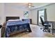 Modern bedroom with light wood flooring, desk area, and a cozy bed perfect for relaxation and work at 475 Spruceview Dr, Port Orange, FL 32127