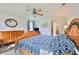 Inviting bedroom features a wooden bed, dresser, ceiling fan, and a tranquil atmosphere for relaxation at 475 Spruceview Dr, Port Orange, FL 32127