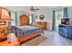 Bright bedroom showcasing a wooden bed frame, an armoire, and ample natural light from the windows at 475 Spruceview Dr, Port Orange, FL 32127