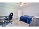 Bright bedroom features a ceiling fan, wood-look tile flooring, and a spacious closet at 475 Spruceview Dr, Port Orange, FL 32127