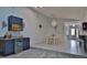 Open-concept dining area features blue cabinets, a wine cooler, and a seashell chandelier, creating an inviting atmosphere at 475 Spruceview Dr, Port Orange, FL 32127