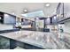 Spacious modern kitchen featuring a large island with countertop seating, stainless steel appliances, and blue cabinetry at 475 Spruceview Dr, Port Orange, FL 32127