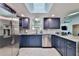 Well-lit modern kitchen with stainless steel appliances, sleek countertops, and stylish blue cabinets at 475 Spruceview Dr, Port Orange, FL 32127