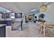 Bright open-concept kitchen and dining area flowing into the living room with stone fireplace, and skylights at 475 Spruceview Dr, Port Orange, FL 32127