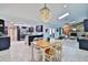 Bright, open-concept layout with modern kitchen, dining area with stylish chandelier, and cozy living room at 475 Spruceview Dr, Port Orange, FL 32127