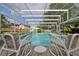 Relaxing screened-in pool and deck with colorful lounge chairs at 475 Spruceview Dr, Port Orange, FL 32127