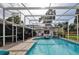 Inviting screened-in pool area with plenty of patio space and tropical landscaping at 475 Spruceview Dr, Port Orange, FL 32127
