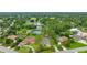 Aerial view highlighting the home's proximity to tennis courts and a picturesque lake at 484 Sweet Bay Ave, New Smyrna Beach, FL 32168