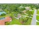 Aerial view of a house featuring mature trees, lush green lawn, and a well-kept yard at 484 Sweet Bay Ave, New Smyrna Beach, FL 32168