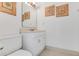 Cozy bathroom with vanity and seashell wall decor at 484 Sweet Bay Ave, New Smyrna Beach, FL 32168