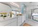 Bright bathroom with a large mirror, white cabinets, and a glass-enclosed shower at 484 Sweet Bay Ave, New Smyrna Beach, FL 32168
