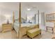 Elegantly designed bedroom with a four-poster bed, neutral colors, and stylish decor at 484 Sweet Bay Ave, New Smyrna Beach, FL 32168