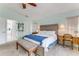 Inviting bedroom with a wooden headboard, blue accents, and a bench at the foot of the bed at 484 Sweet Bay Ave, New Smyrna Beach, FL 32168